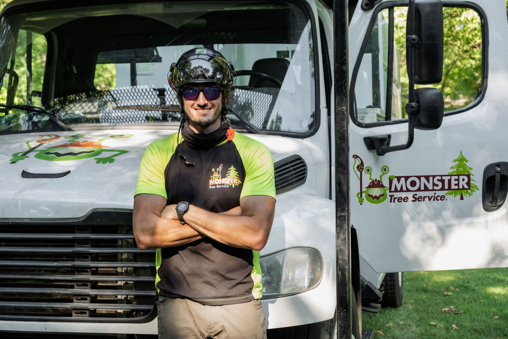 Monster Tree Service franchise owner in front of a branded truck.